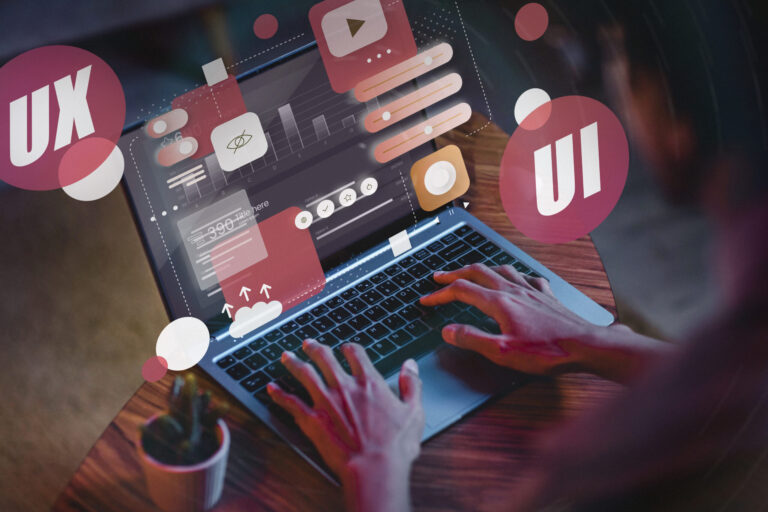 Person typing on a laptop with digital UI/UX design elements and icons overlaying the screen.