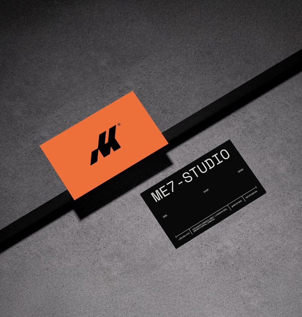 Black business card with an orange geometric logo